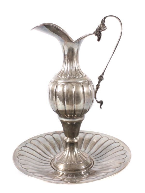 An Italian silver coloured ewer and stand, Palerm: An Italian silver coloured ewer and stand, Palermo, post 1968 .800 standard, with a scroll handle, lobed baluster body and on a circular foot, 34.5cm high, the stand 28cm diameter, 32.1 oz 