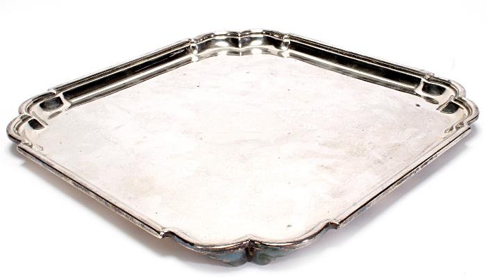A silver square salver by Roberts Belk, Sheffie: A silver square salver by Roberts & Belk, Sheffield 1943, with inset double curved angles, a moulded rim and on four bracket feet, 31cm wide, 36.4 oz
