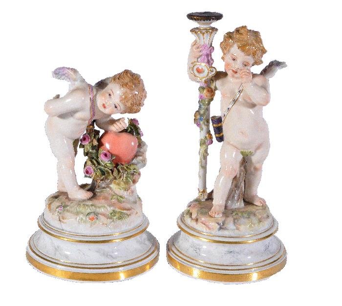 A Meissen model of Cupid, 15.5cm high high, incis: A Meissen model of Cupid, 15.5cm high high, incised L121, blue crossed swords mark; and another Meissen model of a putto, modelled holding a staff, 19cm high, incised L126, blue crossed swords mark, l