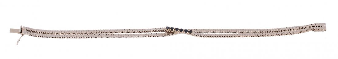 A white gold and sapphire bracelet, by Adriano Chi: A white gold and sapphire bracelet, by Adriano Chimento, Grisignano Di Zocco, the two stranded bracelet, set with six circular cut sapphires, to a concealed box snap clasp, 19.5cm long
