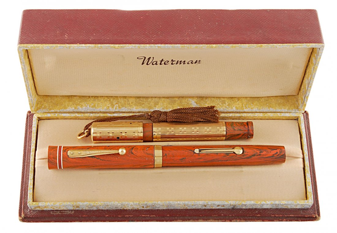 Waterman, two fountain pens , circa 1925, inked: Waterman, two fountain pens , circa 1925, inked, the first a Ripple red Ideal fountain pen, number '5', lever filling system, with red band cap and gilt clip and trim, the flexible nib signed Waterman