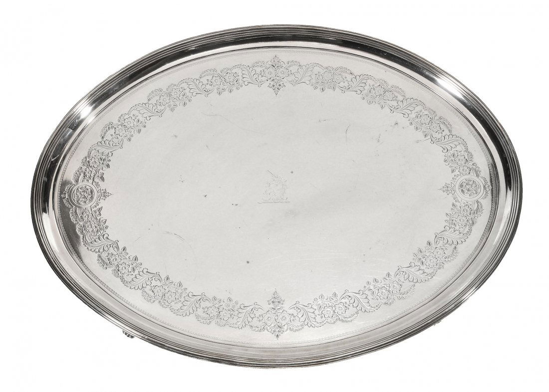 A George III silver oval salver, maker's mark of Robert: A George III silver oval salver, maker's mark of Robert Hennell I & David Hennell II overstriking that of another, London 1799, engraved with a band of flowers and foliage, the raised border with a th