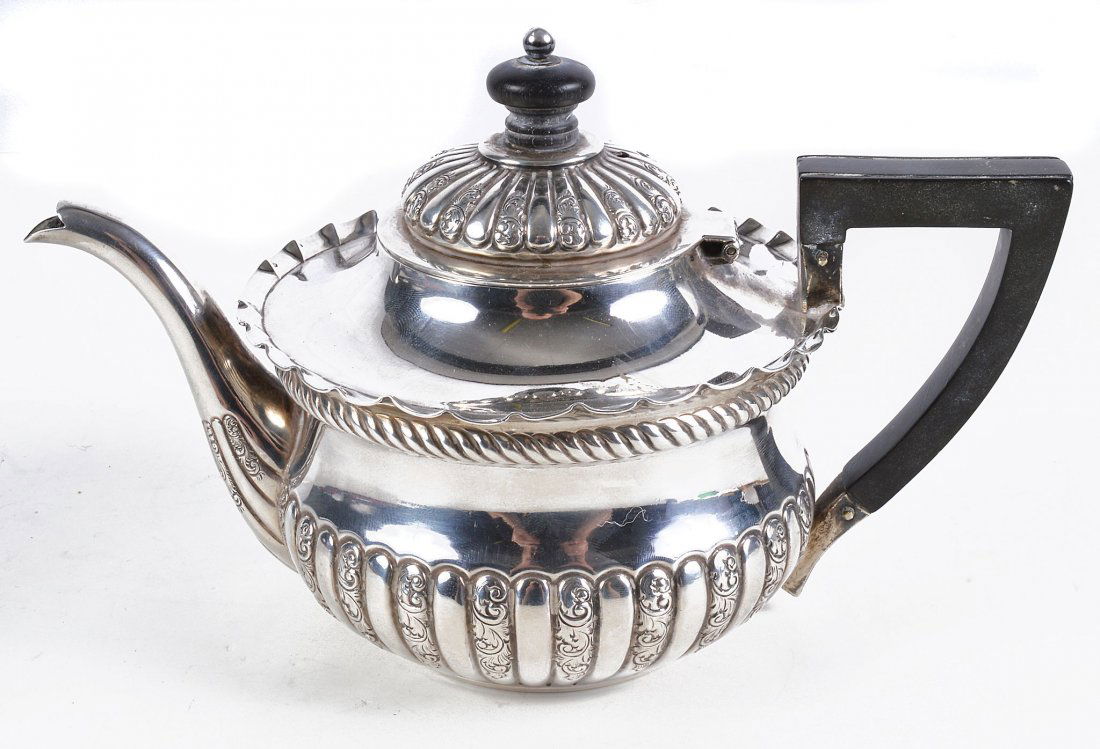 A late Victorian silver bachelors teapot by Vale: A late Victorian silver bachelors teapot by Vale Brothers & Sermon, Birmingham 1893, with an ebony finial and angular handle, a shaped border, the half lobed body embossed with a cable twist band and