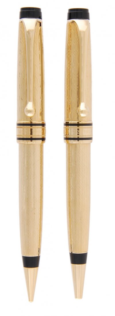 Aurora, Colombo, a limited edition ballpoint pen and: Aurora, Colombo, a limited edition ballpoint pen and mechanical pencil set, no.1013/1492, released 1992, with engine turned decoration throughout, and cap band with engraved caravels, in an Aurora dis