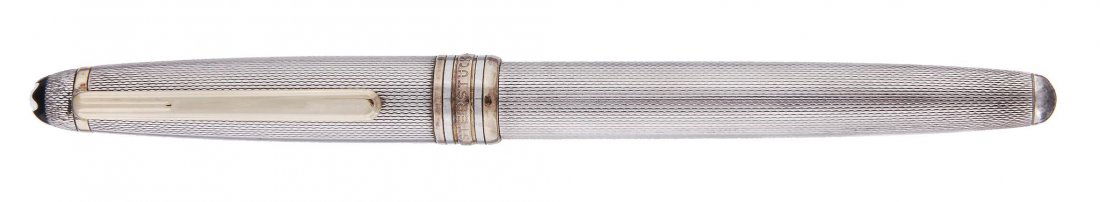 Montblanc, Meisterstuck, a silver coloured roller ball: Montblanc, Meisterstuck, a silver coloured roller ball pen, stamped â€™5', with engine turned barrel and cap, and gold plated clip and trim
