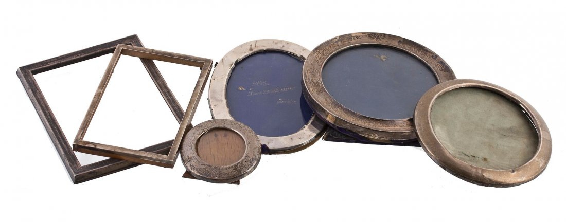 Six silver mounted photo frames, to include: Six silver mounted photo frames, to include: an Edwardian silver mounted circular photograph frame, maker's mark obscured, Chester 1909, 15cm diameter; two other circular photo frames; an oval photo f