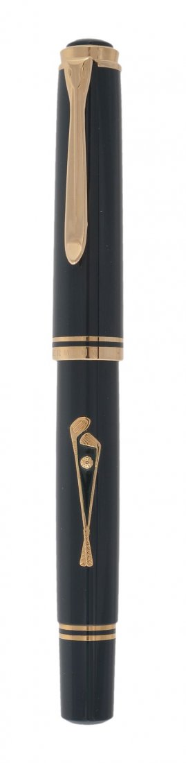 Pelikan, Golf, a limited edition fountain pen, no: Pelikan, Golf, a limited edition fountain pen, no 2534/4500, with a green resin cap and barrel, with gold club detail, the nib stamped 18C, with a piston filling system, in a Pelikan display box with 