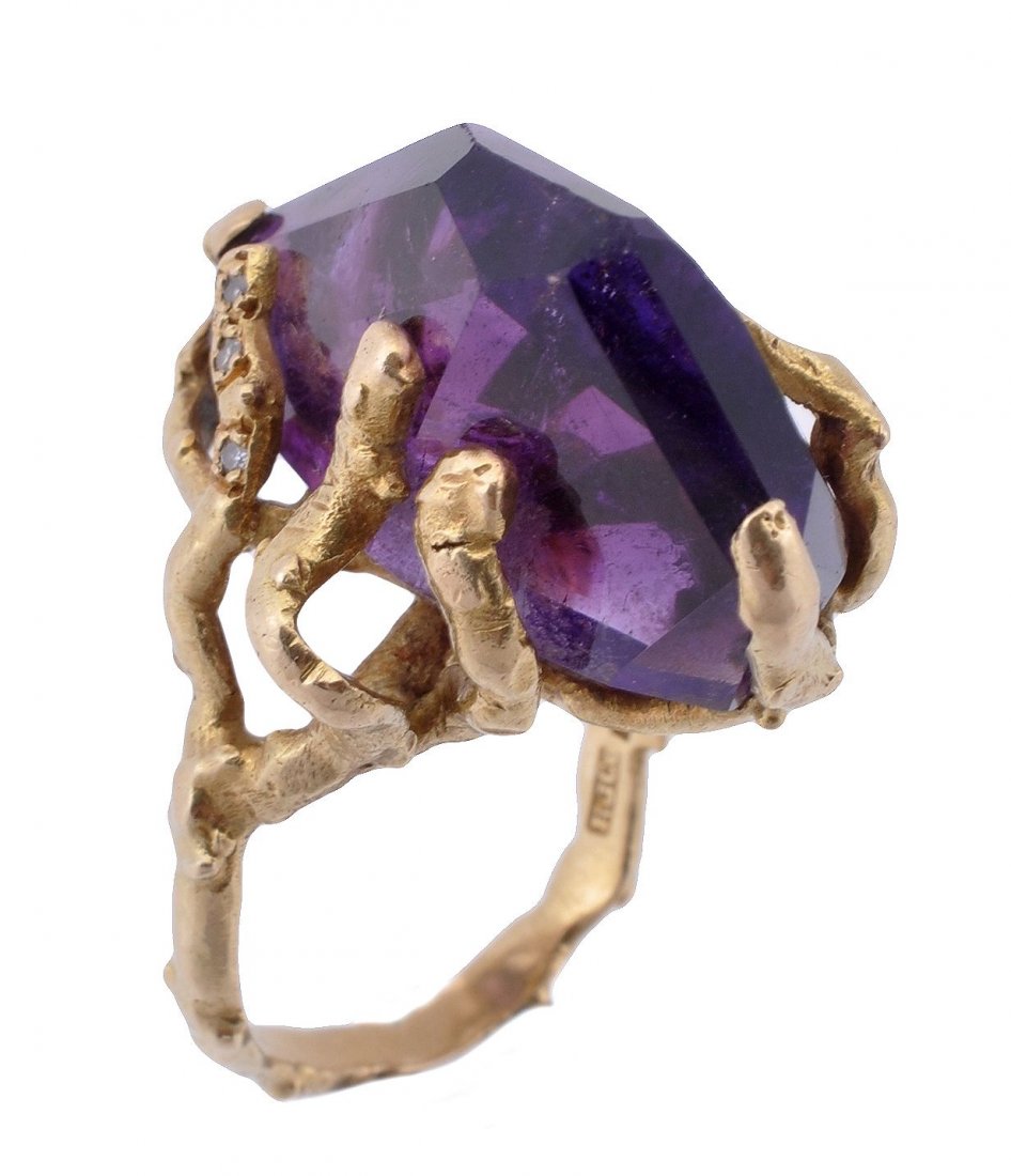 A 1960's amethyst ring by Andrew Grima , the amethyst: A 1960's amethyst ring by Andrew Grima , the amethyst crystal in a textured abstract claw setting with three eight cut diamond accents, mounted in 18 carat yellow gold, signed GRIMA, hallmarked London