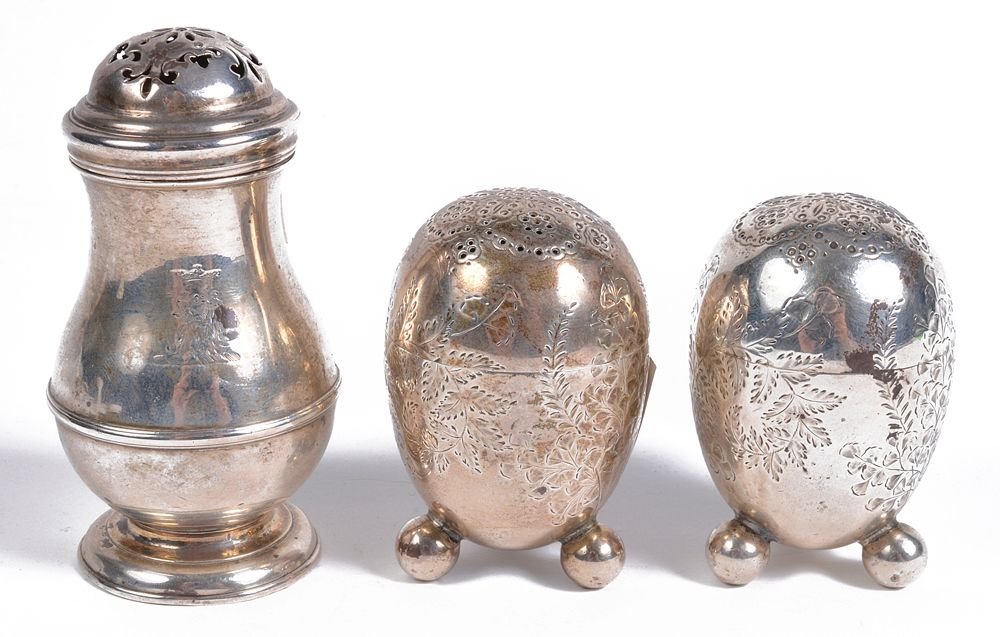 A George I silver baluster pepperette, maker's mark 'W: A George I silver baluster pepperette, maker's mark 'W.F', London 1724, the domed cover with with pierced decoration, engraved with a crest, a girdle and on a circular moulded spreading foot, 8.4cm hi