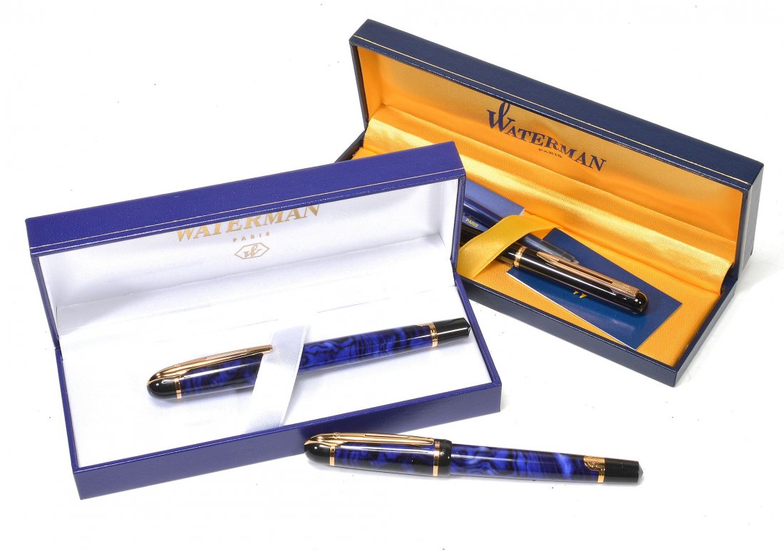 Waterman, a blue and black rollerball pen: Waterman, a blue and black rollerball pen, with a blue and black marbled cap and barrel, the word 'ALCATEL' imprinted to the cap; another the same; and a Waterman, a black fountain pen, with a black c