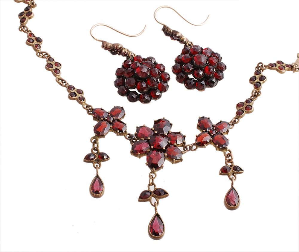 A garnet necklace, the fringe necklace with clusters of: A garnet necklace, the fringe necklace with clusters of rose cut garnets, on a quatrefoil link chain set with further garnets, to a concealed box snap clasp, 40.5cm long; together with a pair similar