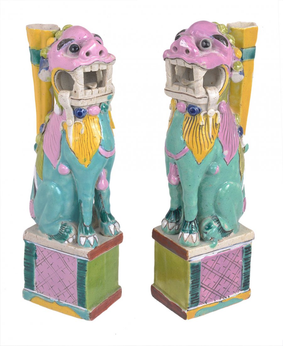 A pair of Chinese porcelain famille rose incense stick: A pair of Chinese porcelain famille rose incense stick holders shaped as Buddhist lions seated on square platforms, early 20th century