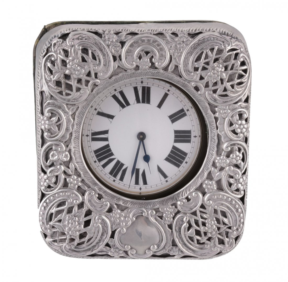 Anon., an Edwardian silver mounted travelling clock: Anon., an Edwardian silver mounted travelling clock case containing an associated nickel cased openface eight day keyless wind Goliath watch, with a three piece screw case, the white enamel dial with 