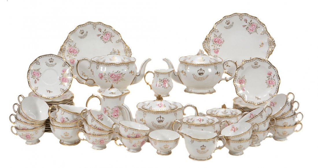 A Royal Crown Derby 'Royal Pinxton Roses' part tea: A Royal Crown Derby 'Royal Pinxton Roses' part tea service by repute ordered by King Farouk of Egypt, date code for 1957, gilt with crown and Arabic script, comprising; a pair of sandwich plates, thre