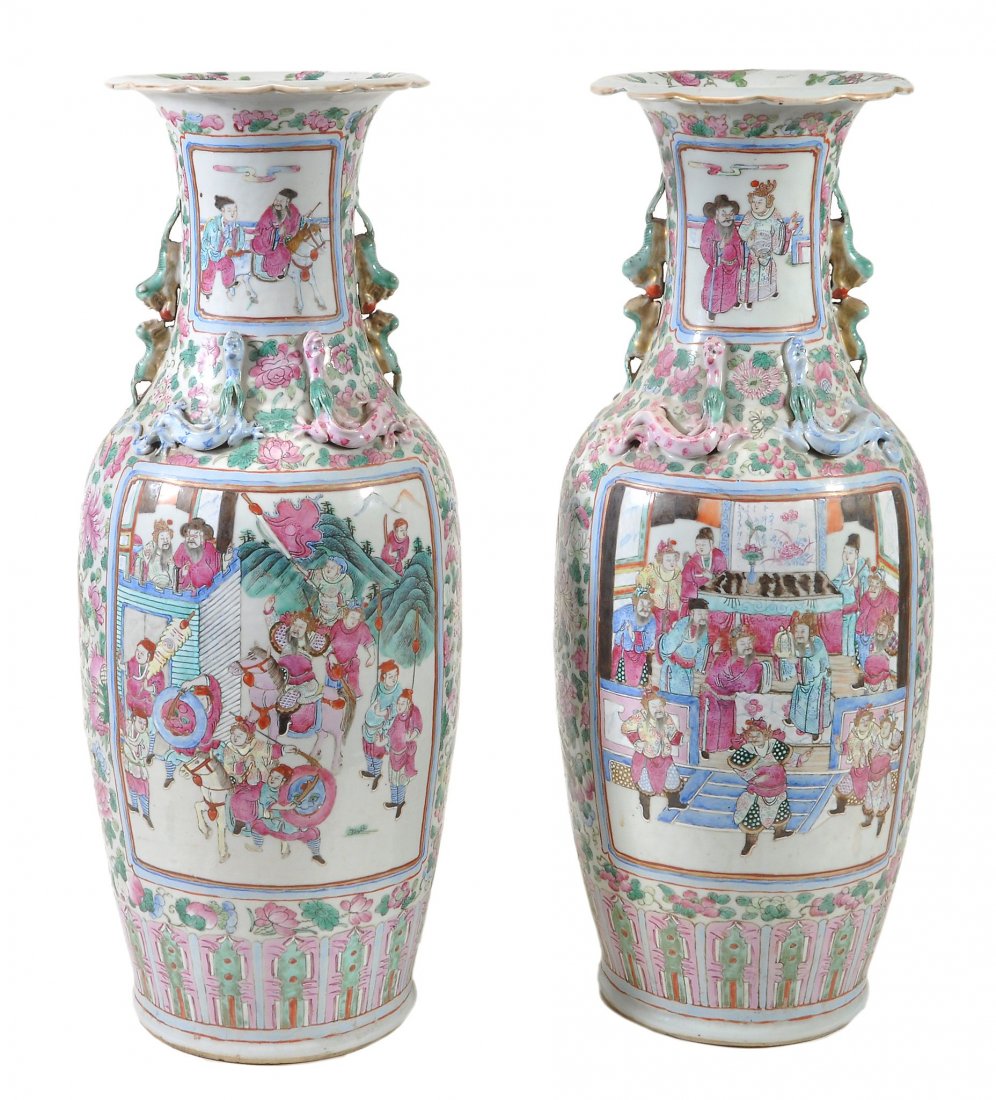 A pair of famille rose Canton vases, 19th century: A pair of famille rose Canton vases, 19th century, each of ovoid form rising to a waisted neck with everted, lobed mouth, the shoulders applied with confronting dragons and with Buddhist dogs shaped h