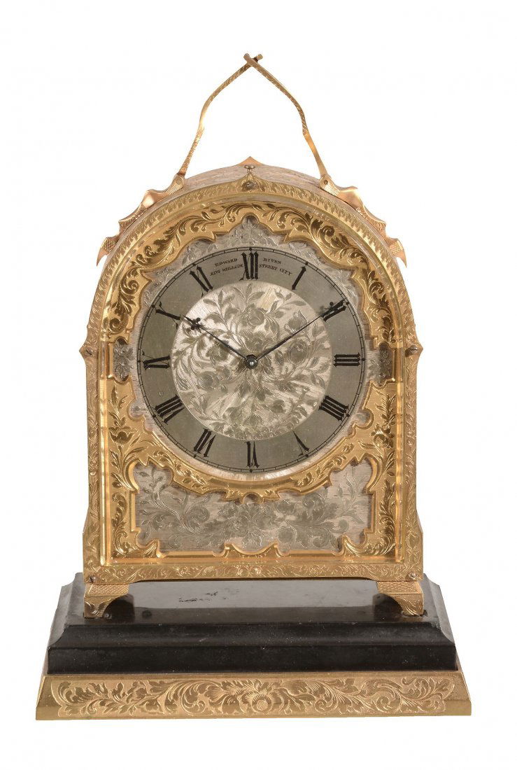 A fine Victorian engraved gilt brass hump-back carriage: A fine Victorian engraved gilt brass hump-back carriage clock with push-button repeat and original black marble inset stand Probably by Thomas Cole for retail by Edward Biven, London, circa 1845 The r