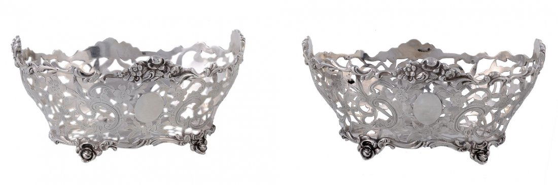 A pair of late Victorian silver oval baskets by Charles: A pair of late Victorian silver oval baskets by Charles Stuart Harris, London 1897, the scroll cast rims with flowers at the quarters, the sides pierced and engraved with flowers, foliage and C-scroll