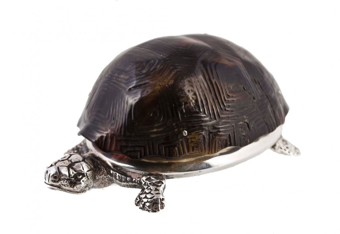A Victorian silver and tortoiseshell vesta case by: A Victorian silver and tortoiseshell vesta case by Thomas Johnson II, London 1881 , modelled as a tortoise, the naturalistically modelled tortoise shell hinged to one side to reveal a raised body with