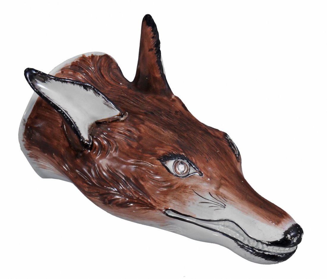 A Staffordshire pearlware fox head stirrup cup , circa: A Staffordshire pearlware fox head stirrup cup , circa 1800, with painted brown head, mouth and ears edged in black, 15.5cm in length