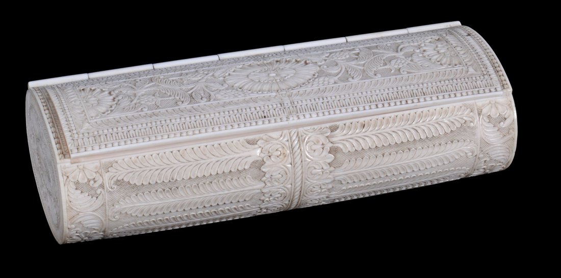 An Anglo-Indian carved ivory oval-section box, late: An Anglo-Indian carved ivory oval-section box, late 19th century, with a hinged cover, delicately carved overall with foliage and acanthus, 18.5cm long