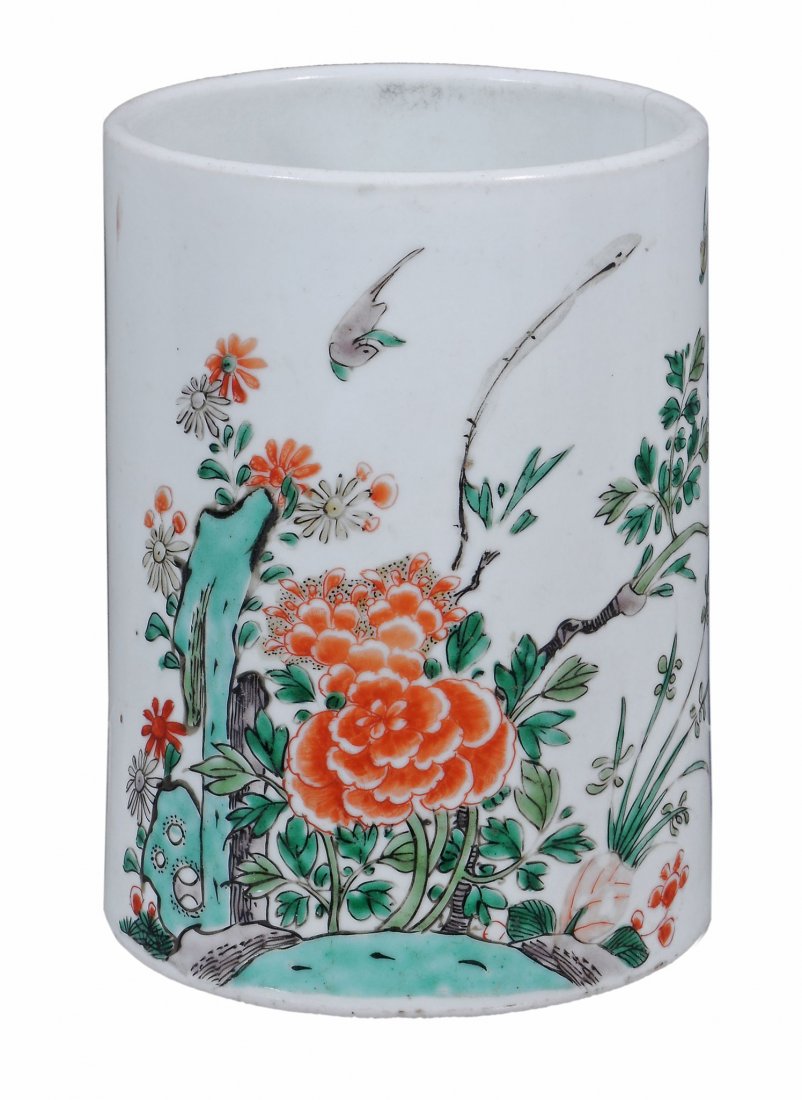 A cylindrical Chinese famille verte brush pot, Qing: A cylindrical Chinese famille verte brush pot, Qing Dynasty, Kangxi (1662-1722), decorated with birds, peonies and green rocks with calligraphy on the reverse, 14cm high