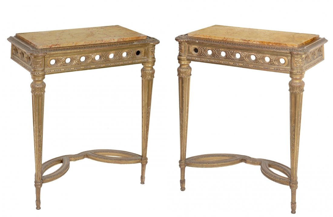 A pair of giltwoood console tables, in Louis XVI style: A pair of giltwoood console tables, in Louis XVI style, early 20th century each with inset variegated marble top, pierced frieze on tapering legs joined by stretchers 77cm high, 65cm wide, 33cm deep