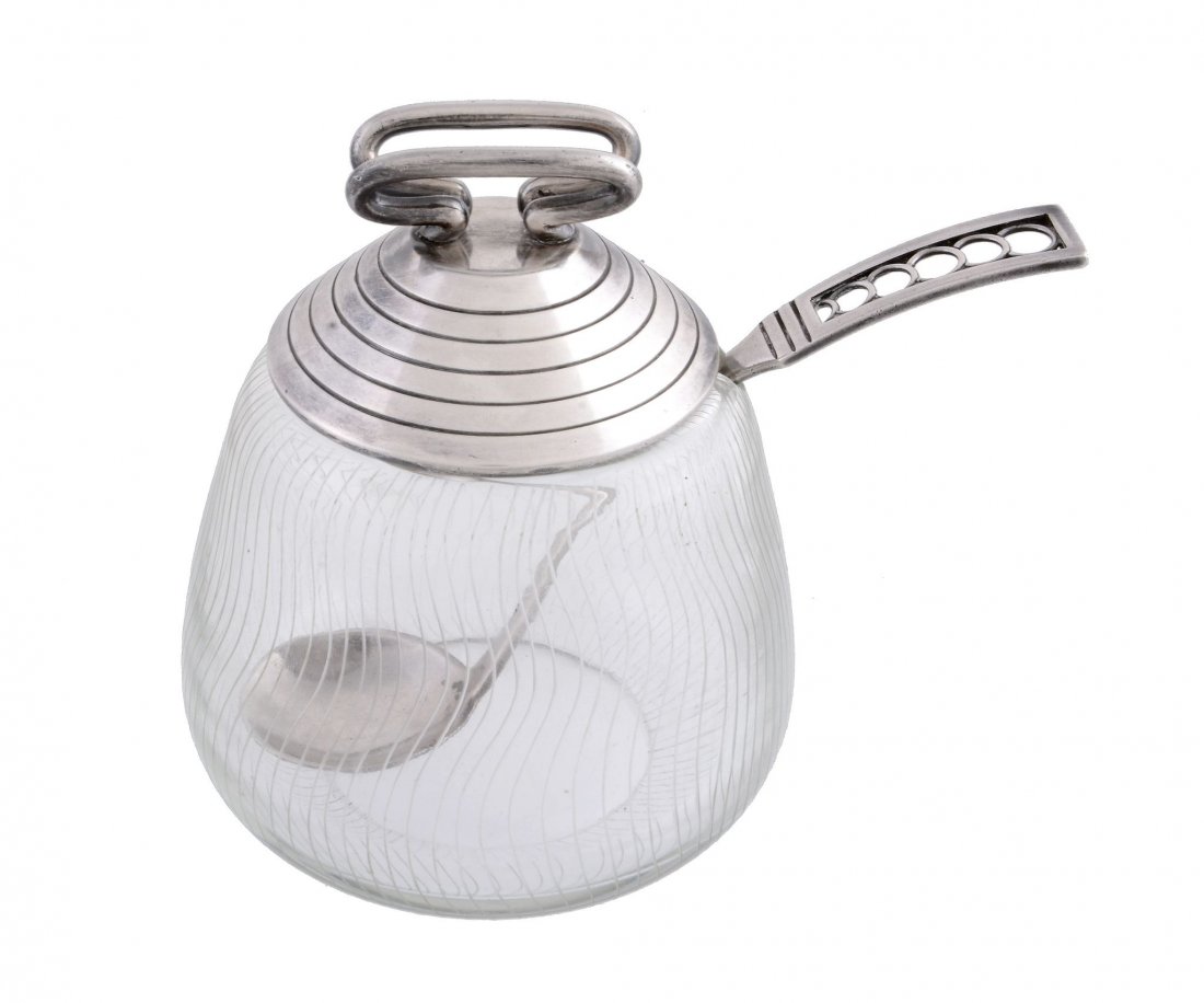 A Danish silver lidded glass preserve pot and spoon by: A Danish silver lidded glass preserve pot and spoon by F. Hingelberg, Aarhus, stamped marks, .925 standard, probably designed by Svend Weihrauch (1899-1962), with a twin loop finial to the slope sided