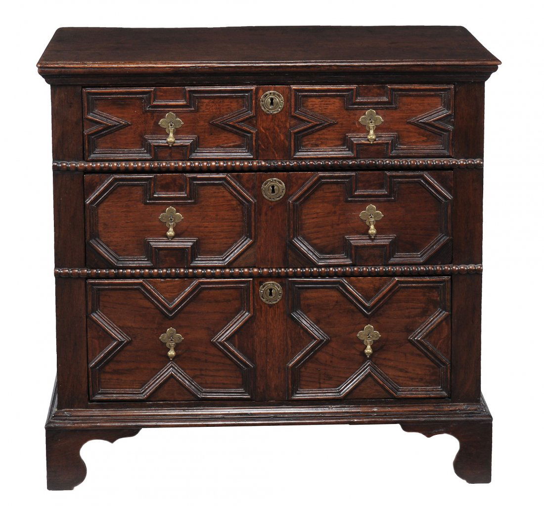 A late 17th century and later oak chest of drawers,: A late 17th century and later oak chest of drawers, circa 1690, with bobbin turned mounts, the three drawers with geometric moulded panels to fronts, on later bracket feet, 87cm high, 88cm wide, 49cm
