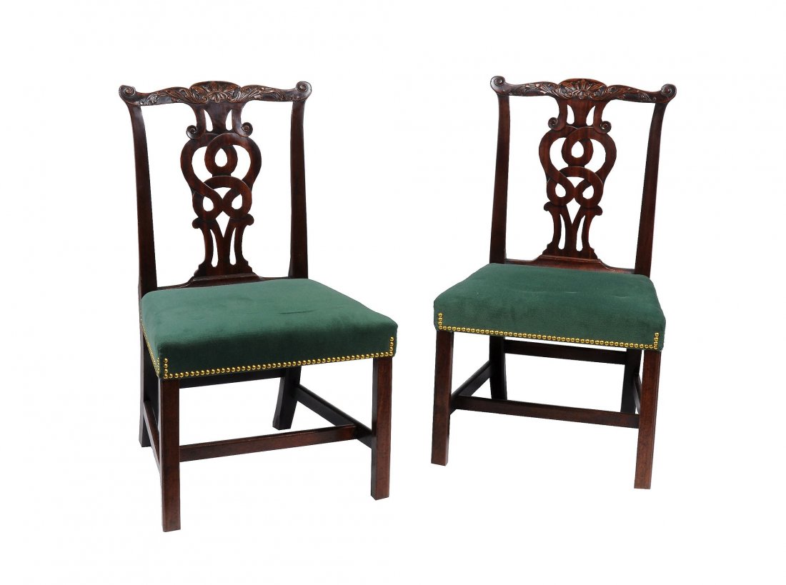 A pair of George III mahogany dining chairs , circa: A pair of George III mahogany dining chairs , circa 1780, after a design by Thomas Chippendale , the carved top-rail with foliate carving above a decorative pierced splat and overstuffed seat, on squa