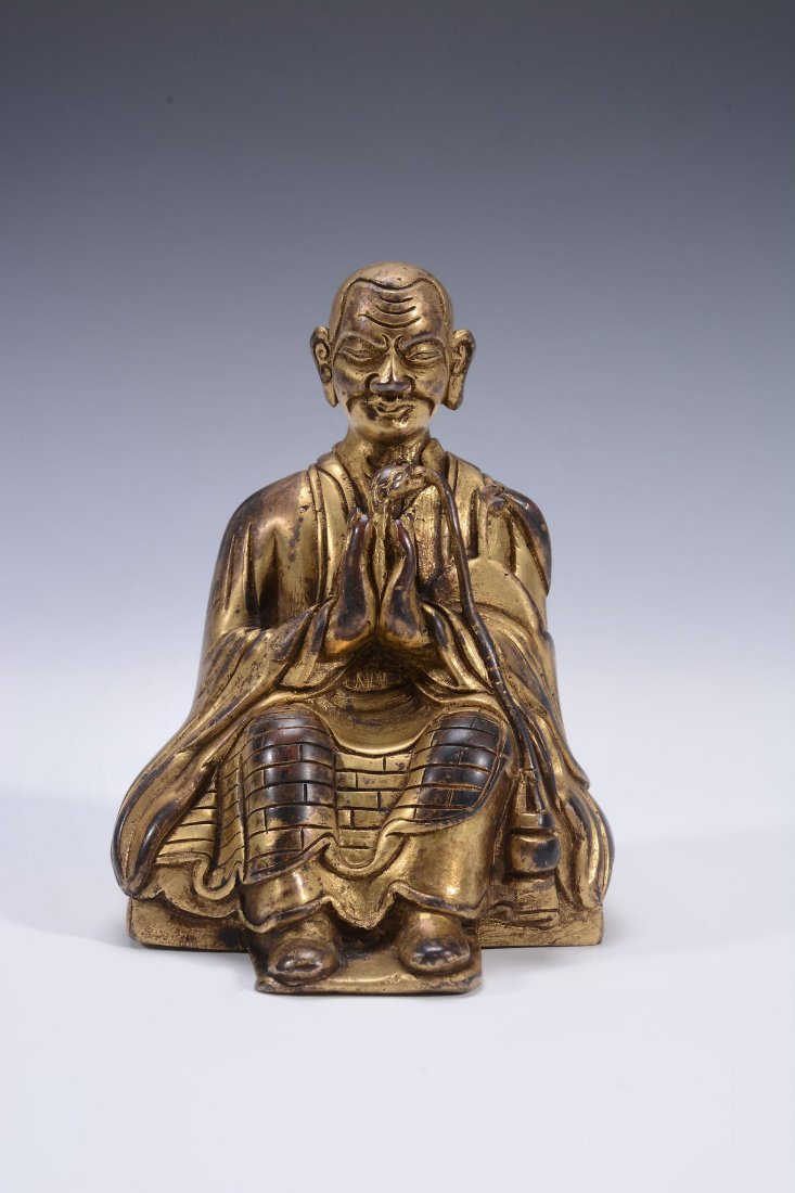 A Tibetan gilded figure of a monk, 18th century (1 of 3)