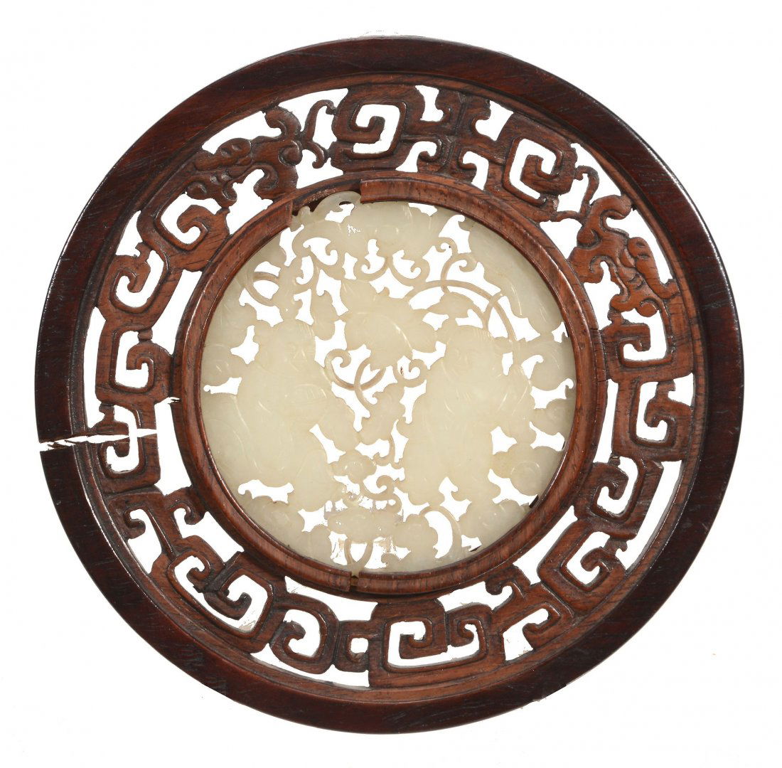 A Chinese white jade roundel, late Qing Dynasty (1 of 2)