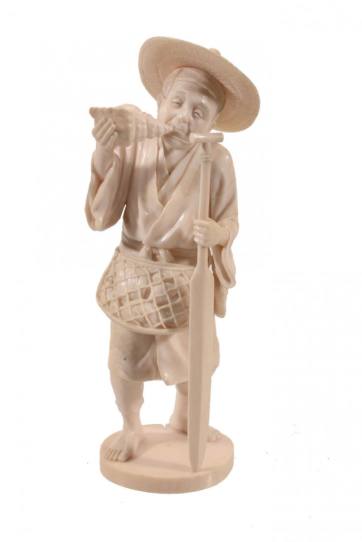 An Ivory Okimono of a Fisherman Blowing a Conch (1 of 2)