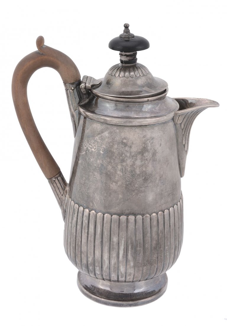 A Victorian silver hot water pot by Charles Stuart: A Victorian silver hot water pot by Charles Stuart Harris, London 1881, with a composition finial and loop handle, half lobed, engraved with a crest, 18.5cm (7 1/4in) high, 353g (11.35 oz) gross The c