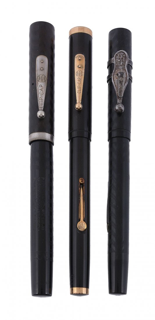 Waterman's, Ideal, a black fountain pen, the cap and: Waterman's, Ideal, a black fountain pen, the cap and barrel with engraved decoration, the nib stamped 5, with a lever filling system; together with two further Waterman's fountain pens