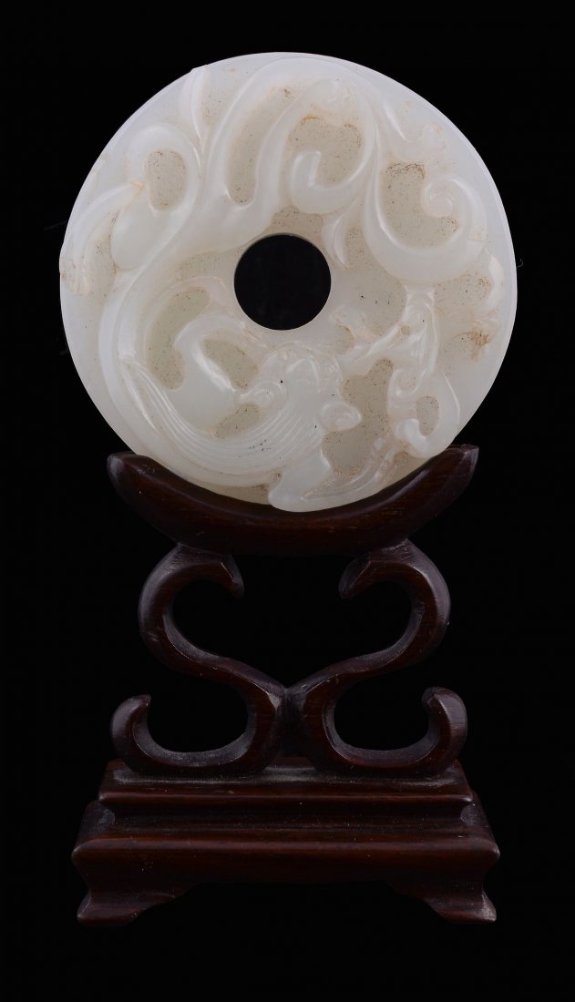 A Chinese pale celadon or white jade disc, Bi (1 of 2)