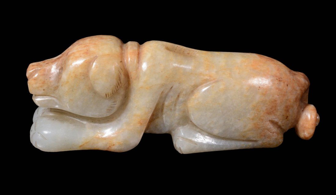 A Chinese white and russet jade dog, lying facing (1 of 2)