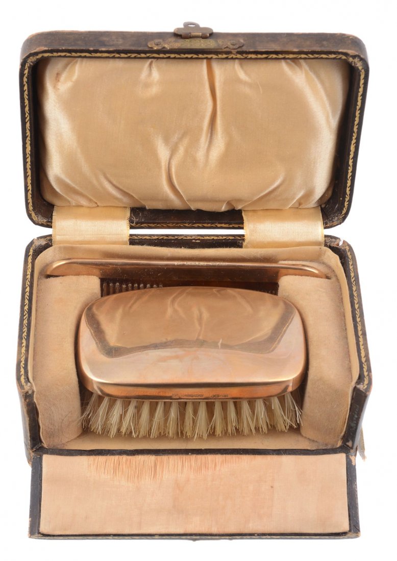A plain 9 carat gold mounted hair brush and comb by: A plain 9 carat gold mounted hair brush and comb by William Neale & Son Ltd , Birmingham 1927, import marked for Dublin 1927, the brush 9cm (3 1/2in) long, in a case