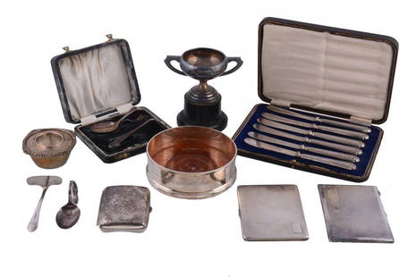 A collection of silver items, to include: a silver: A collection of silver items, to include: a silver mounted wine coaster by Asprey, London 1987, with a beaded border and engraved To Richard Dunn on the occasion of his 50th Birthday and as a token of