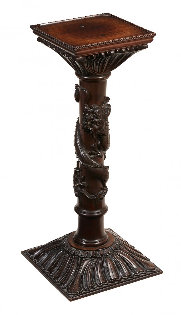 A Chinese hardwood pedestal, carved with an entwined (1 of 3)