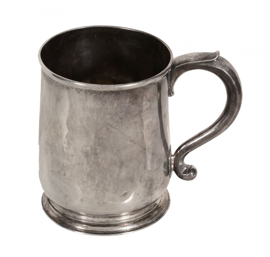 A George I silver slightly tapered mug by George: A George I silver slightly tapered mug by George Wickes, London 1725, with a slightly everted rim, a tongue-capped S-scroll handle and a domed foot, later engraved beneath A.C.C. from H.M. 1887 and 17