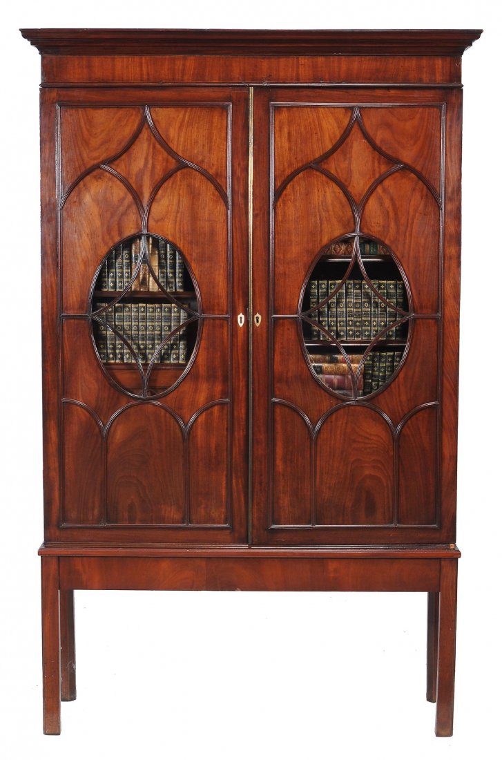 A George III mahogany bookcase cabinet, circa 1770: A George III mahogany bookcase cabinet, circa 1770, in the manner of Thomas Chippendale, opening to adjustable shelves on a mahogany stand, in George III style, 20th century , overall 208cm high, 130c