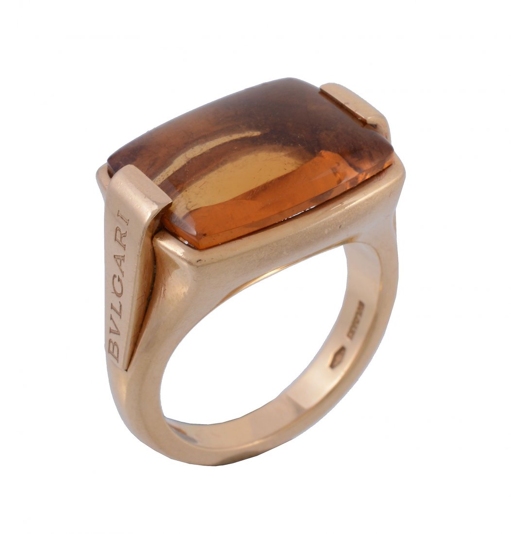 An 18 carat gold citrine ring by Bulgari, the: An 18 carat gold citrine ring by Bulgari, the rectangular buff top citrine in a collet setting signed Bulgari, stamped 750 with Italian control marks, finger size O 1/2