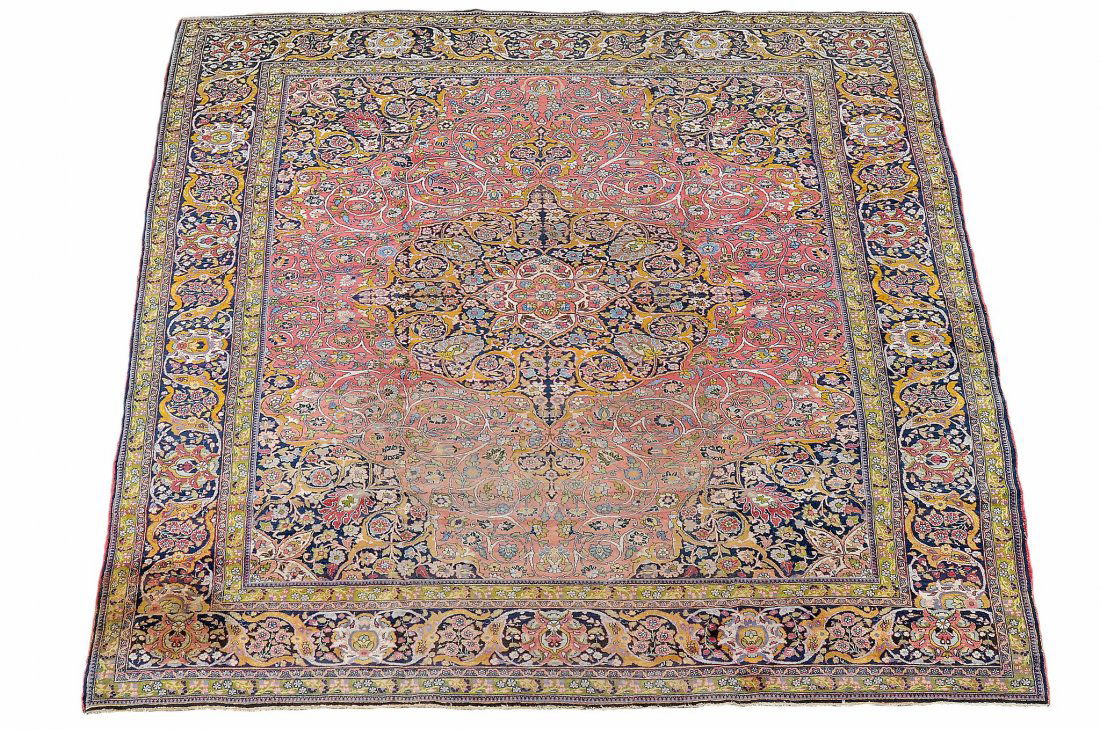 A Tabriz carpet , the madder field centred by a navy (1 of 3)