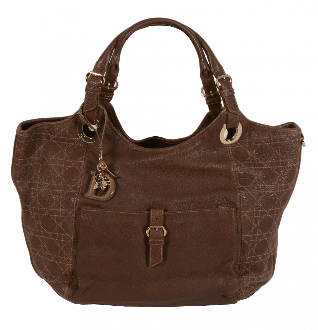 Christian Dior, a brown leather tote bag, with twin: Christian Dior, a brown leather tote bag, with twin loop handles, a pocket and metal hardware, the zip opening to a satin interior with three pockets, 40 x 27 x 19cm, with a Dior dust bag and paperwor