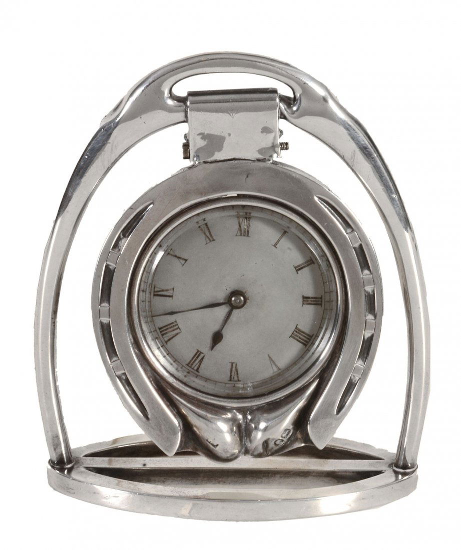 A Victorian silver cased novelty 'horseshoe: A Victorian silver cased novelty 'horseshoe' time-piece by William Frederick Williams, London 1879 The frame formed as a stirrup with central swing hinge suspending a glazed Roman dial framed by a sil