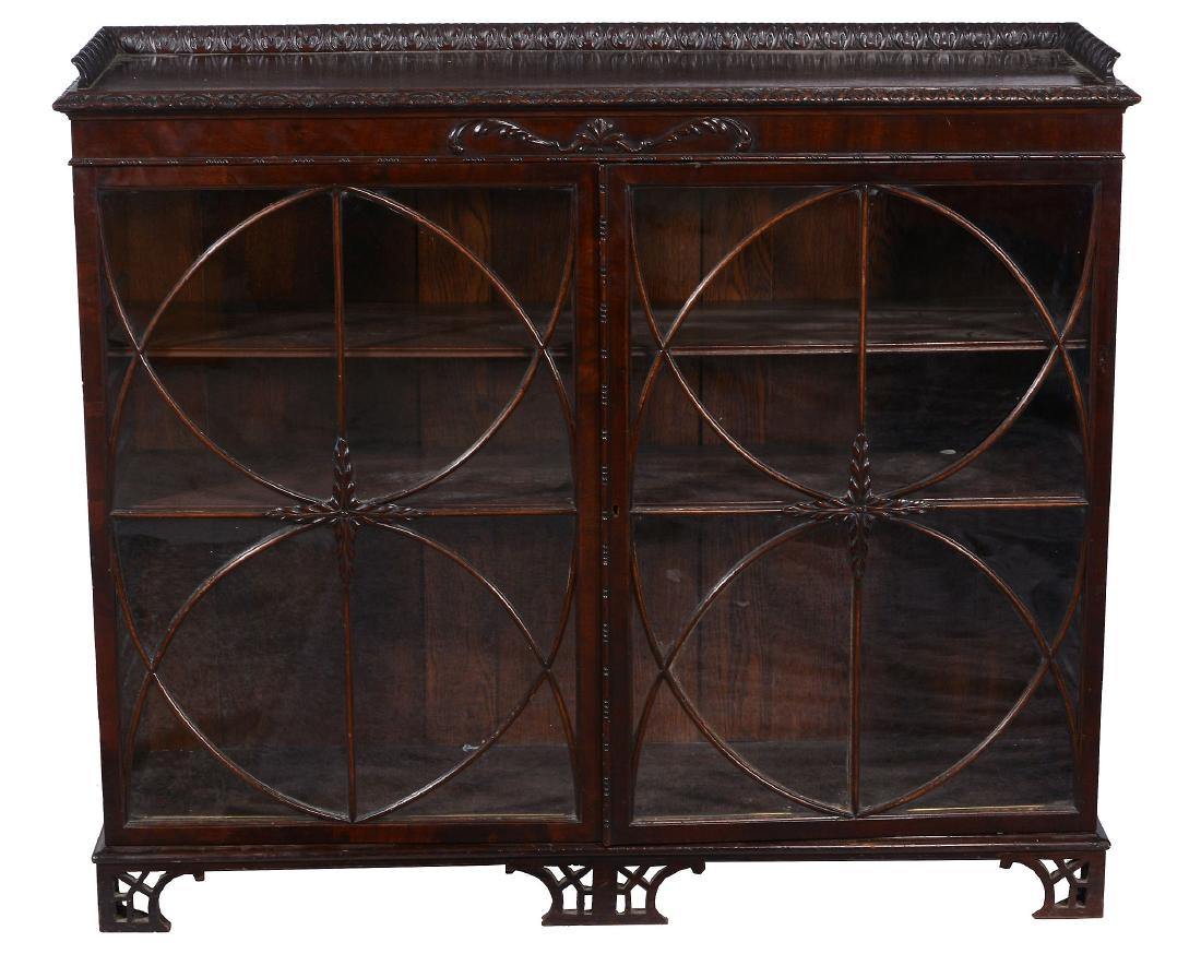 A mahogany dwarf bookcase in George III style , early: A mahogany dwarf bookcase in George III style , early 20th century, after the manner of Thomas Chippendale, with two adjustable shelves, and DRUCE & CO label to rear, 104cm high, 122 wide, 36cm deep