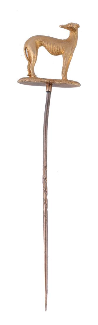 A late 19th century grey hound stick pin, circa 1880: A late 19th century grey hound stick pin, circa 1880, the greyhound standing four square, with textured coat, 2cm tall