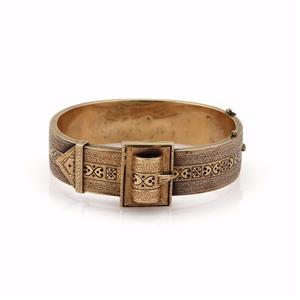 Victorian 14k Yellow Gold Enamel Fancy Belt Design: This lovely Victorian bracelet is crafted from 14k yellow gold with a smooth and textured finish. The front of the band has a belt design with black enaml hearts and dots. It fastens with a push in cl