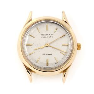 Tiffany & Co. Vintage 14k Yellow Gold 34.5mm Watch: This is an Tiffany & Co. wrist watch. The case is crafted from 14k yellow gold featuring a 34.5mm round shape. Metallic pale gold face with gold tone hands and hourmarkers. (The original movement was