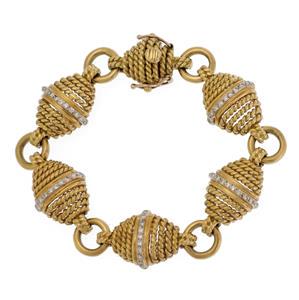 Cassis Diamond 18k Yellow Gold Cable Wire Fancy Link Bracelet: This beautiful designer bracelet is signed from the Cassis Collection, crafted from 18k yellow gold featuring rhombus shape links with graduated rows of fine cable wire, larger from the center, the